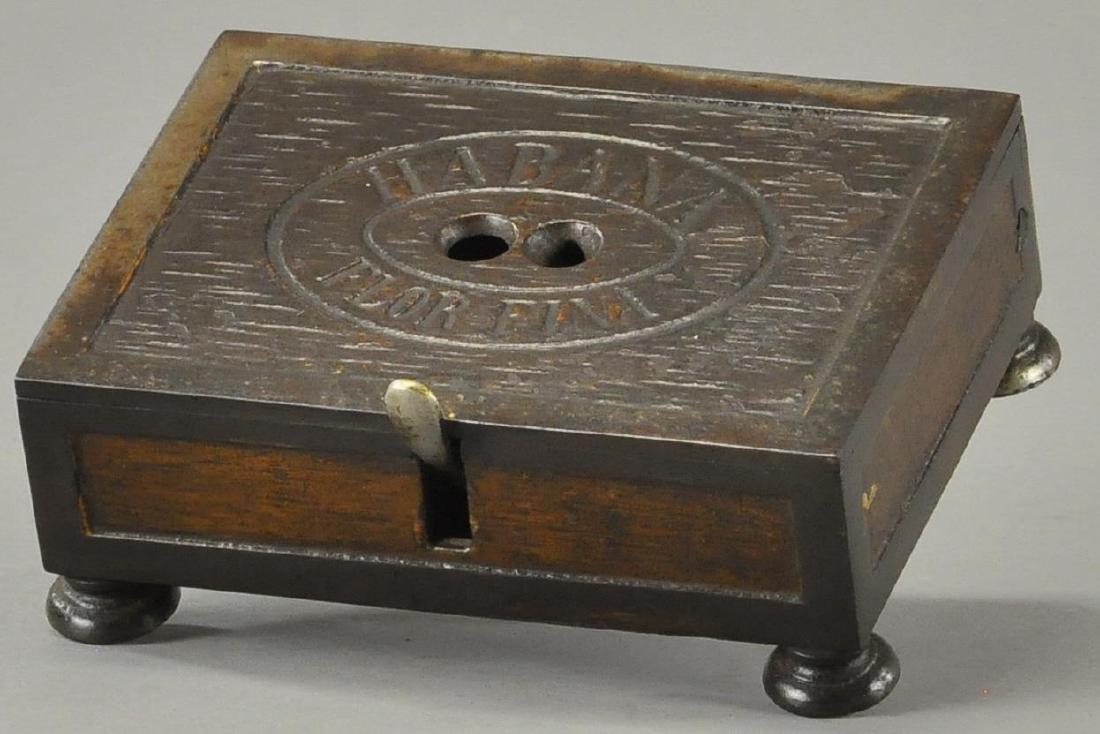 HABANA FLOR FINA CIGAR CUTTER: 343 HABANA FLOR FINA CIGAR CUTTER Cast iron, depicted as a wooden cigar box. 5" h. (Exc. Cond.)