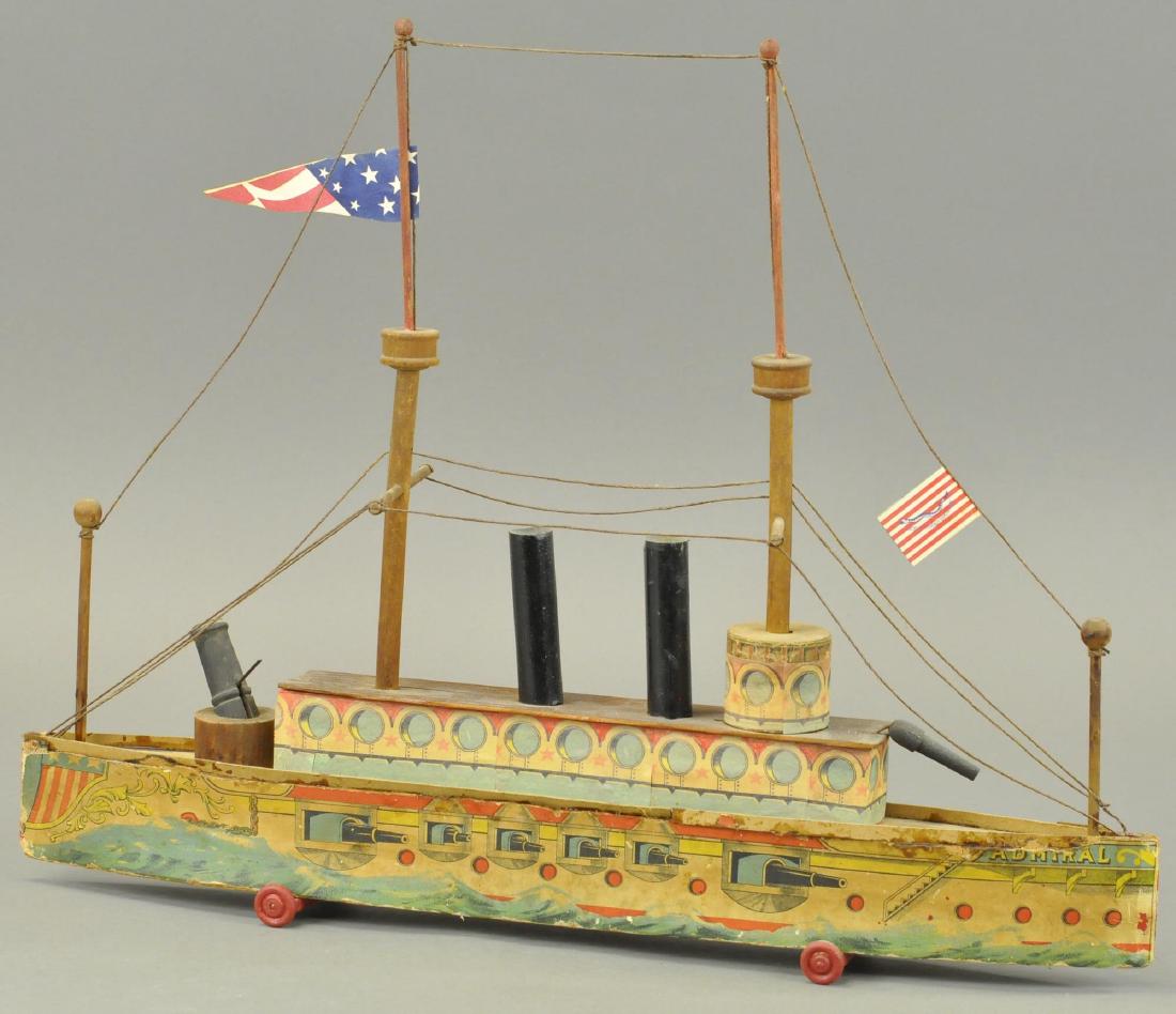 BLISS ADMIRAL BATTLESHIP: 388 BLISS ADMIRAL BATTLESHIP 20" L. Paper on hull is original, otherwise replaced, flags and wheels are replaced.