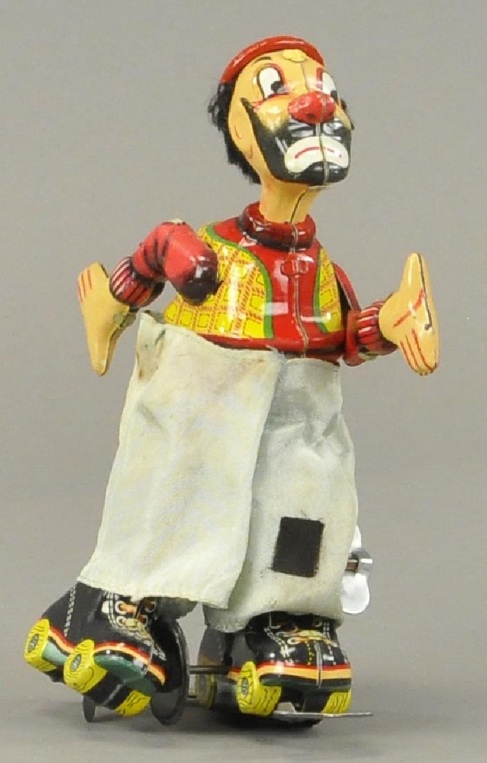 TPS HOBO ROLLER SKATER JAPANESE WIND UP: 521 TPS HOBO ROLLER SKATER JAPANESE WIND UP Minor factory touch ups as is common on Japanese tin toys.