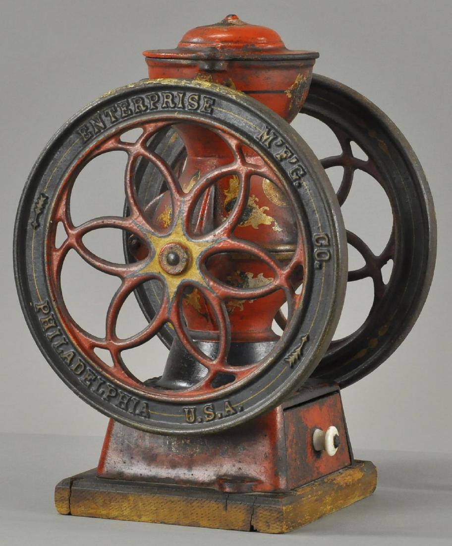 SMALL STORE COUNTER TOP GRINDER: 519. SMALL STORE COUNTER TOP GRINDER | (VG Cond.) | "Enterprise Mfg. Co., Philadelphia, USA" embossed on both wheels and base, stencil décor throughout, some age appropriate wear, cast iron drawer on