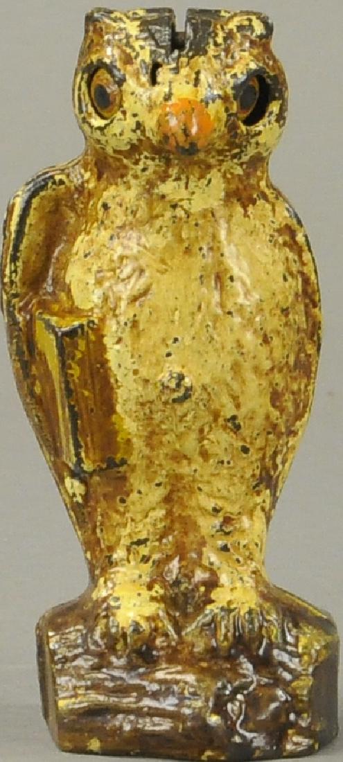 OWL SLOT IN HEAD MECHANICAL BANK: 945. OWL SLOT IN HEAD MECHANICAL BANK | Kilgore Mfg. Co., circa 1920's, coin deposit in top of head causes owls eyes to blink.
