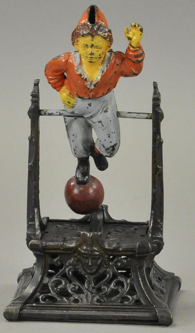 BOY ON TRAPEZE MECHANICAL BANK: 960. BOY ON TRAPEZE MECHANICAL BANK | Formally known as the "French's Automatic Toy Bank," Philadelphia PA c. 1888, offered here without any common cracks or breaks to finials.