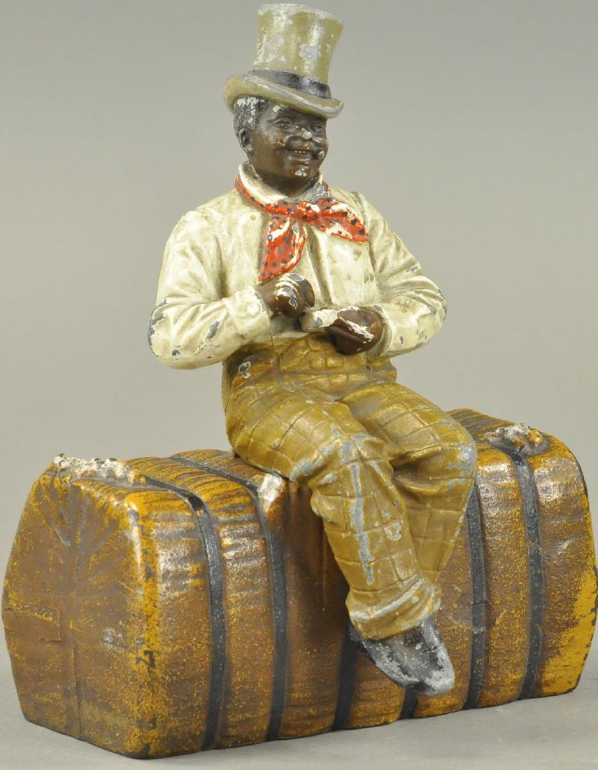 MAN ON BALE OF COTTON DOORSTOP (1 of 3)