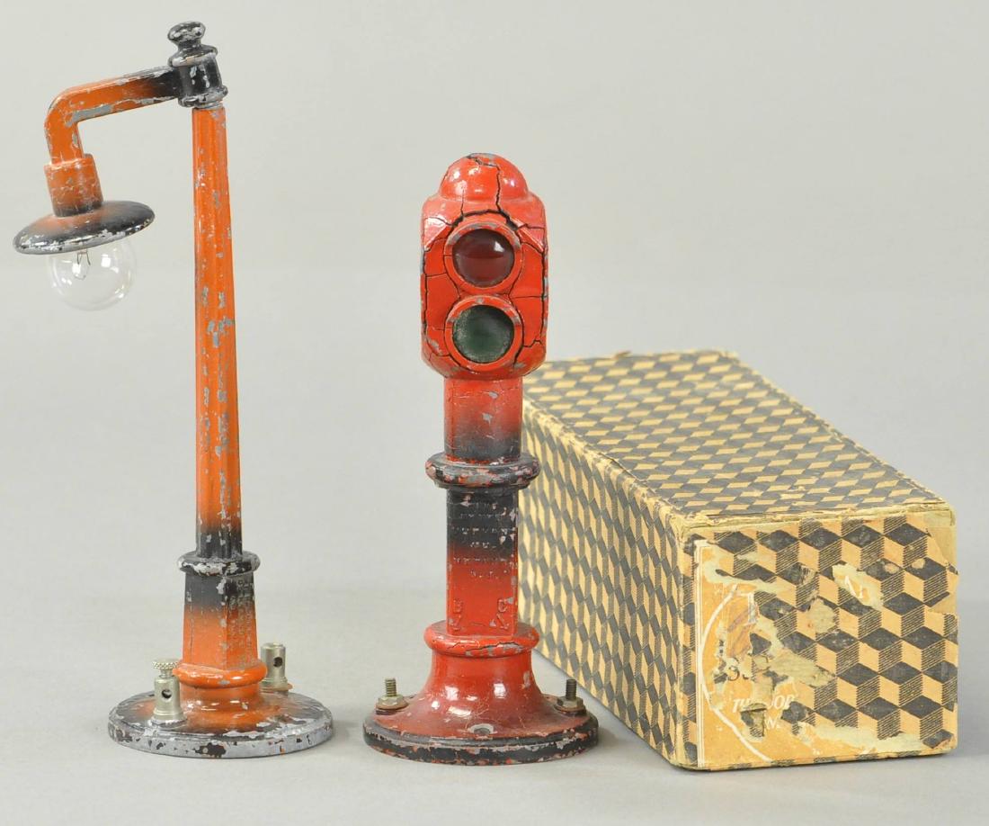 TWO DORFAN TRAIN ACCESSORIES: 311. TWO DORFAN TRAIN ACCESSORIES | Lamp arm broken off of post, traffic signal casting is cracking. (VG Cond.) | 7" h.