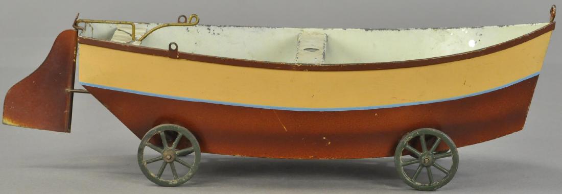 GERMAN TIN SAILBOAT ON WHEELS: 1050. GERMAN TIN SAILBOAT ON WHEELS | Missing wooden mast and paper sails, paint in All Original Condition. | 15.5" l.