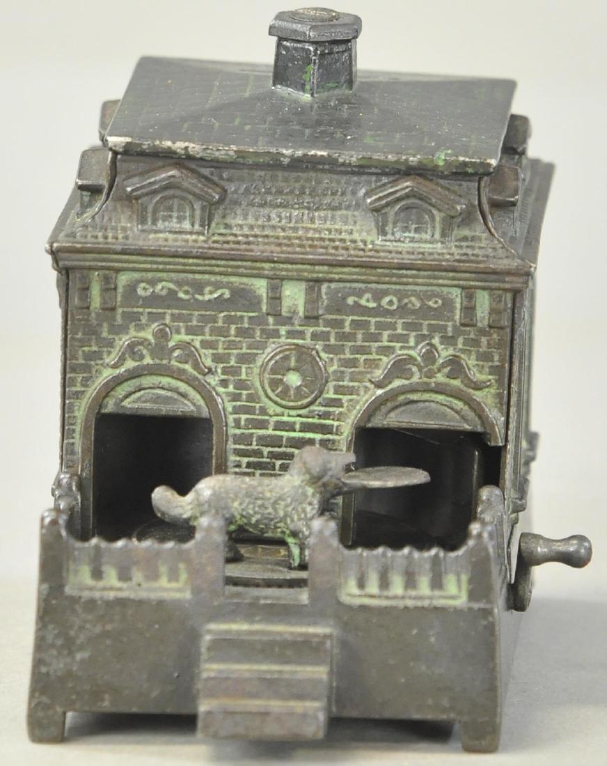 DOG ON TURNTABLE MECHANICAL BANK: 1308. DOG ON TURNTABLE MECHANICAL BANK | Roof replaced, otherwise in All Original Condition. | Nice ebony coloring with green patina.