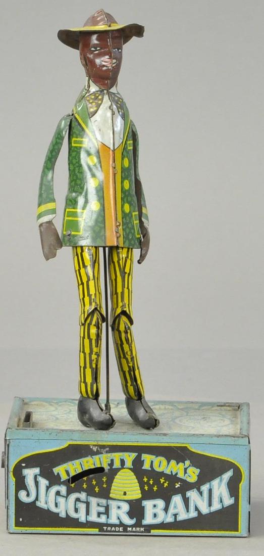 THRIFTY TOM JIGGER MECHANICAL BANK: 1491. THRIFTY TOM JIGGER MECHANICAL BANK | Missing activation lever, otherwise All Original Condition. | 10" l.