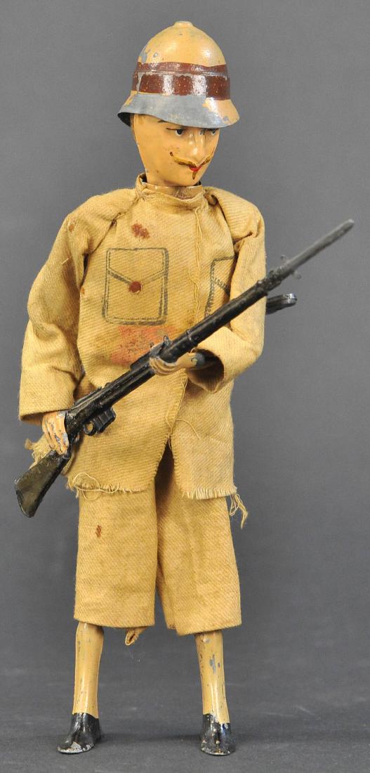 MARTIN KHAKI SOLDIER: 241. MARTIN KHAKI SOLDIER | c. 1900 "Le Gentleman Khaki". Clockwork mechanism, a reference to the Boer War in South Africa, this soldier is dressed in a Khaki cloth uniform with helmet, when wound his