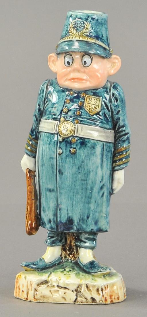 MAJOLICA CONSTABLE BROWNIE: 109. MAJOLICA CONSTABLE BROWNIE | Palmer Cox policeman w/night stick, candle holder. 8" h.