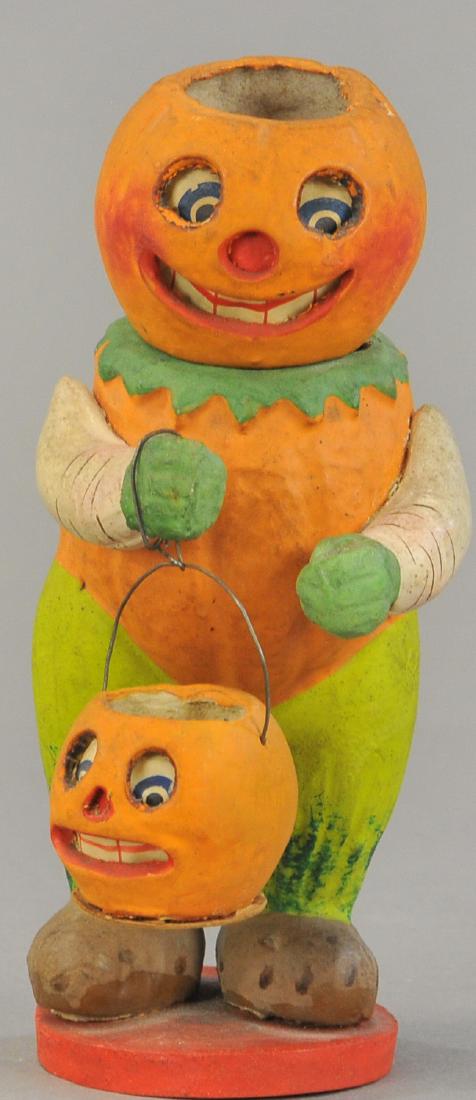COMBINATION JACK-O-LANTERN AND CANDY CONTAINER: 1509. COMBINATION JACK-O-LANTERN AND CANDY CONTAINER | Pre- 1920's German composition piece, the head of the Jack-O-Lantern removes and can be used as a lantern, he has amusing potato feet, and is hol