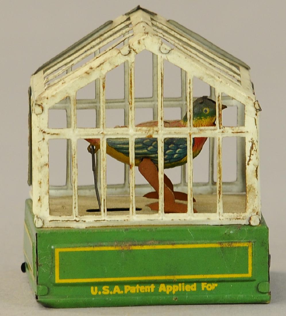 WIND-UP BIRD IN CAGE PENNY TOY: 25. WIND-UP BIRD IN CAGE PENNY TOY | 3" l.