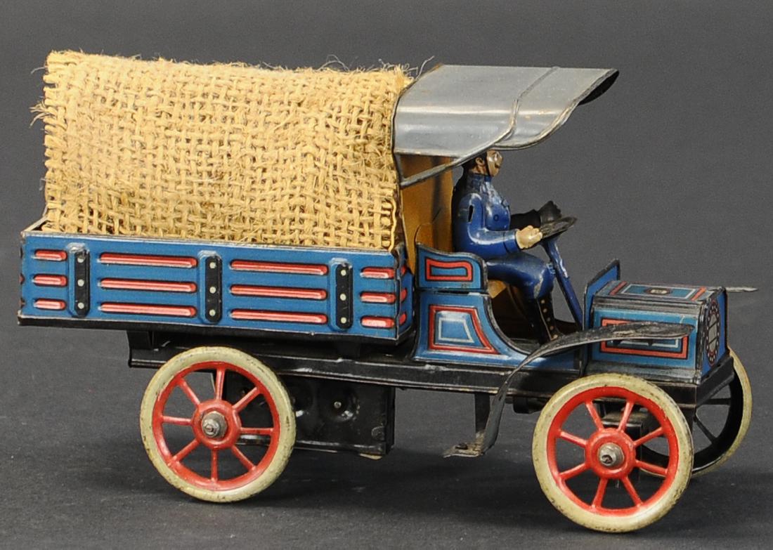 GUNTHERMANN OPEN BED TRUCK WITH CANVAS COVER: 428. GUNTHERMANN OPEN BED TRUCK WITH CANVAS COVER | Wind-up, small mechanism fixed to rear axle, horizontal bar running length of bed holds canvas cover. | 7.5" l.