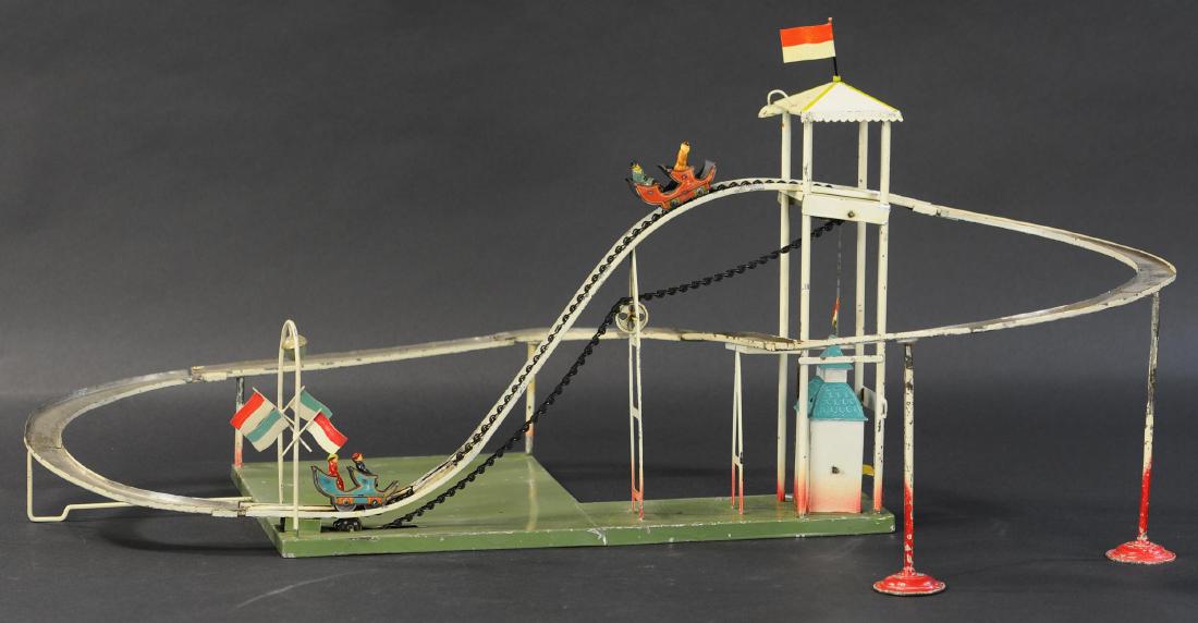 BING ROLLER COASTER STEAM TOY: 511. BING ROLLER COASTER STEAM TOY | Litho cars with passengers roll down through the turns and are then grabbed by a conveyer chain that carries them back to top to repeat the thrill. | 31" l x 20" w