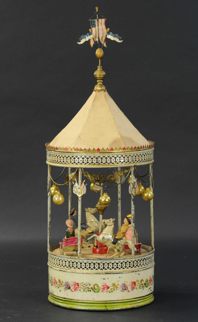 LARGE PLINK PLANK CAROUSEL: 514. LARGE PLINK PLANK CAROUSEL | Wind-up toy, plays a music box tune as it spins. | 26" h.