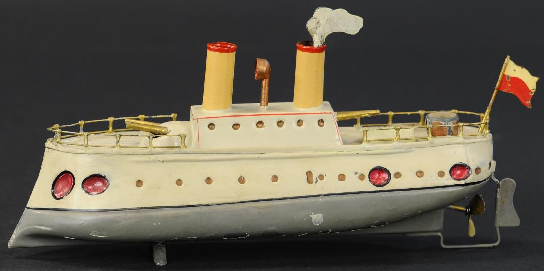 SMALL STAUDT SHOVEL-NOSED GUNBOAT: 586. SMALL STAUDT SHOVEL-NOSED GUNBOAT | Small clockwork ship wound by an exhaust cloud-shaped key rising from one of its two stacks, features three cannons and a brass compass on its rear deck. Book 