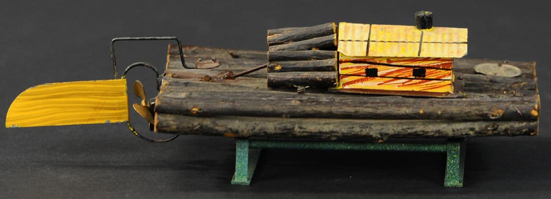 ERNST PLANK LOG HOUSE BOAT: 667. ERNST PLANK LOG HOUSE BOAT | Wind-up log raft made of real wooden sticks fastened together in Ernst Planks shop many decades ago, has a tinplate wheel house that hides the clockwork mechanism, a 