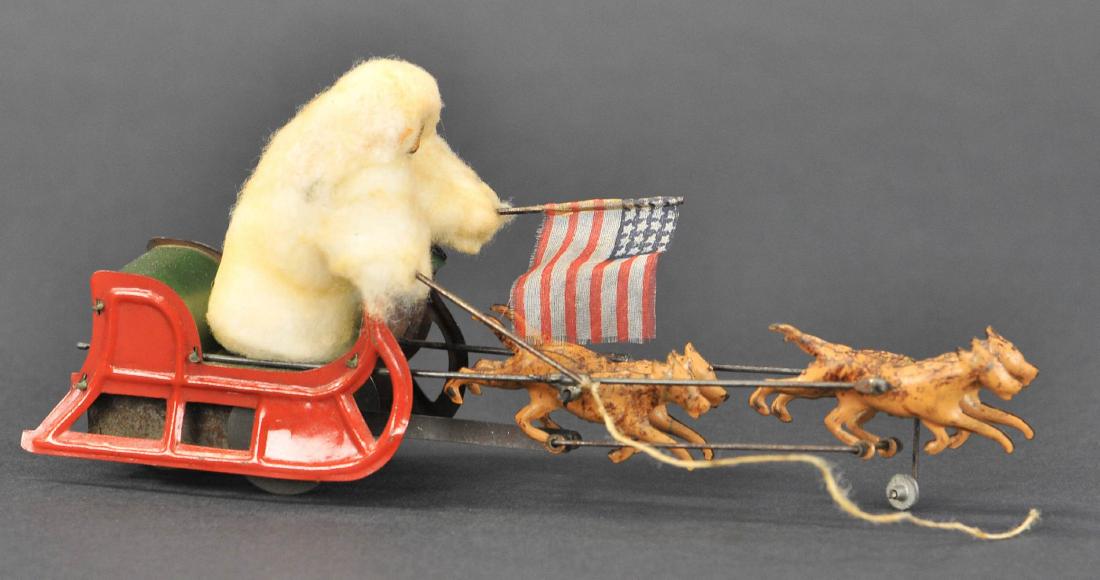 MARTIN ADMIRAL PEARY ON DOG SLED: 1. MARTIN ADMIRAL PEARY ON DOG SLED | c. 1909, "La Conquete du Pole Nord", cotton robed figure stands on tin dog sleigh drawn by four dogs in flight, exceptional visuals when clockwork is activated. |