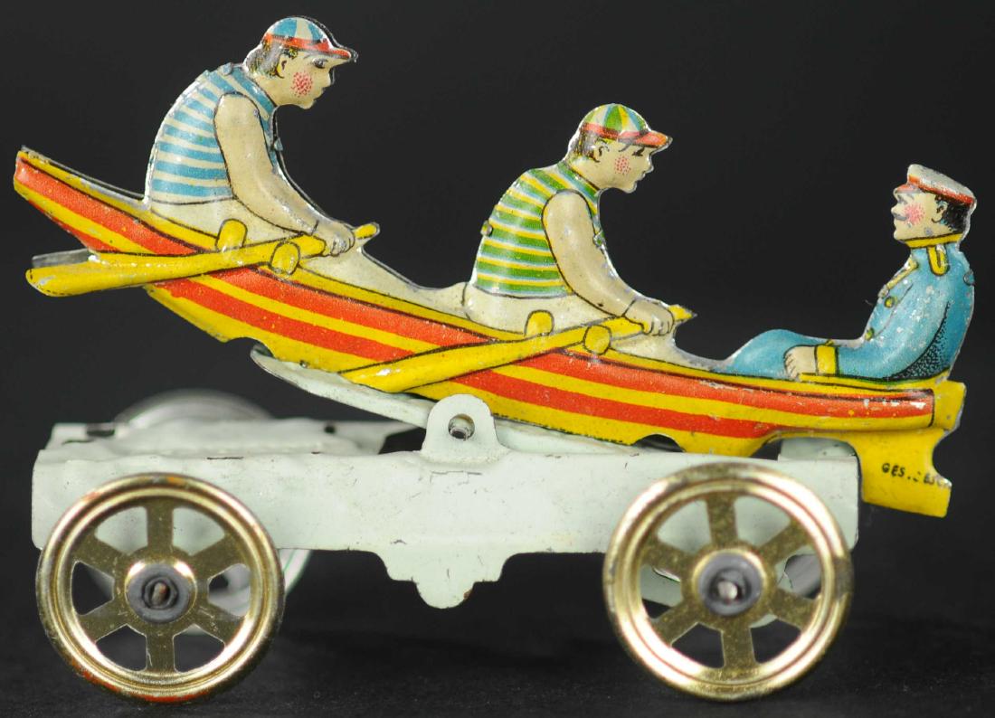 MEIER MEN IN ROWBOAT PENNY TOY: 107. MEIER MEN IN ROWBOAT PENNY TOY | Scarce articulated axle version of popular toy, as piece is pushed along, the articulated axle causes boat to rock over waves.
