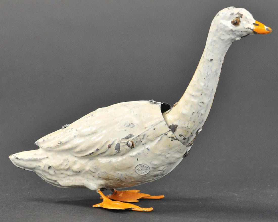 FERNAND MARTIN GOOSE: 133. FERNAND MARTIN GOOSE | c. 1899, rather scarce early tin toy, features clockwork activated waddling goose with nice embossed details, known as "Loie". | 6" h.