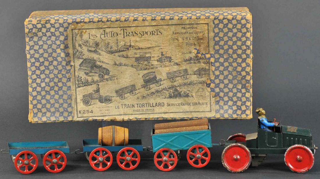 VICTOR BONNET "LE TRAIN TORTILLARD" W/ BOX: 138. VICTOR BONNET "LE TRAIN TORTILLARD" W/ BOX | The fifth toy in the series of "Les Auto-Transports" produced between 1919-1937 by Bonnet, clockwork mechanism allows the tractor to pull all of the t