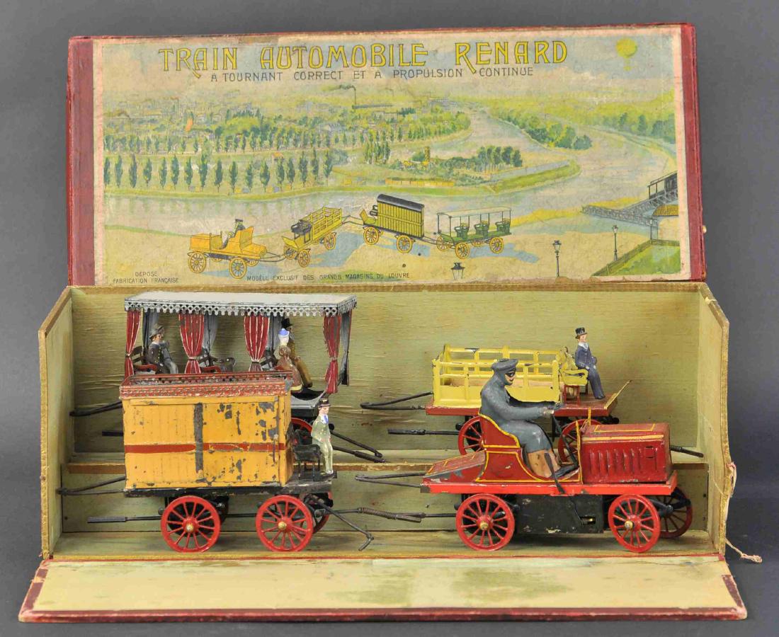 LE TRAIN RENARD WITH ORIGINAL BOX CASE: 139. LE TRAIN RENARD WITH ORIGINAL BOX CASE | France, c. 1903, an older model of "Le Train Tortillard" by Bonnet, the vibrant colored train cars move along by the drive shaft of the lead tractor, w/ o