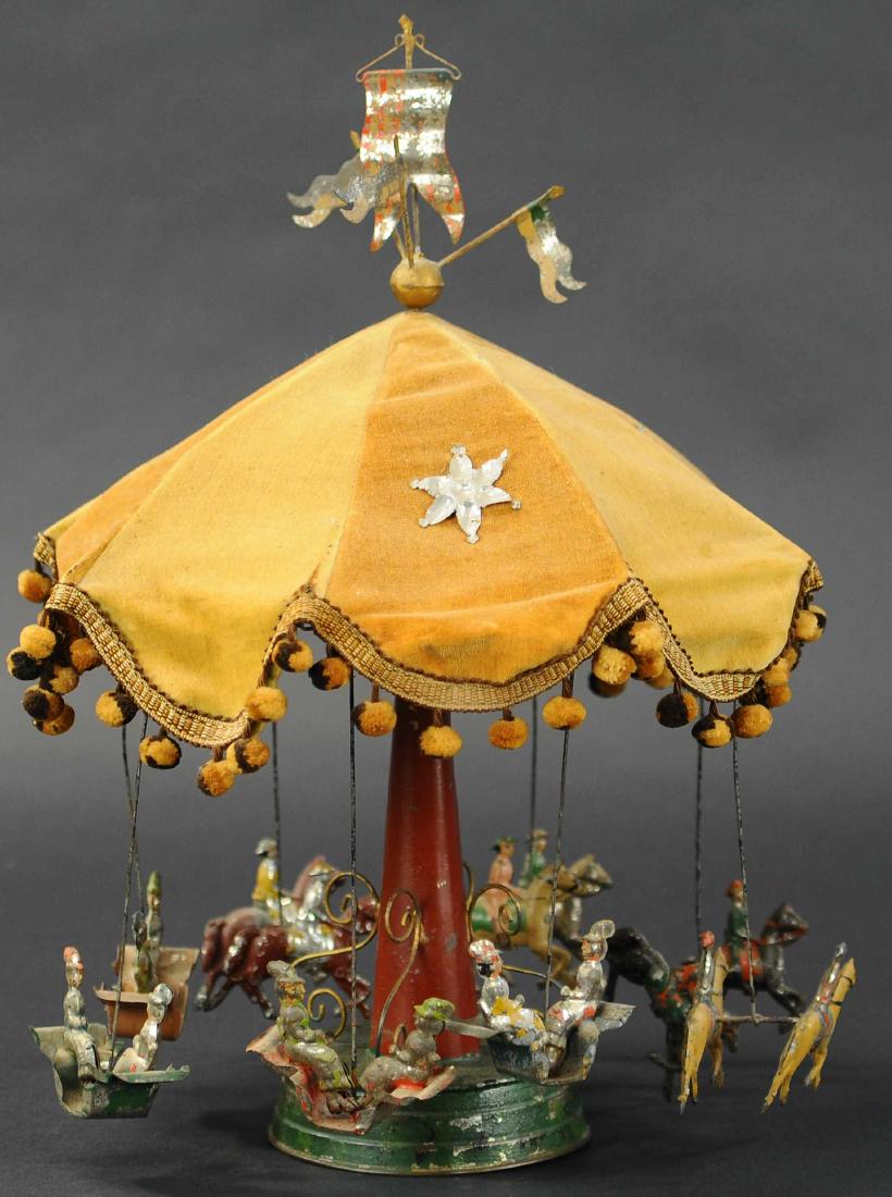 EUROPEAN MERRY-GO-ROUND: 145. EUROPEAN MERRY-GO-ROUND | Germany, attributed to Gunthermann, hand painted tin, ornate tower support with canopy top, four gondolas with seated figures and eight carousel horses and seats with fi