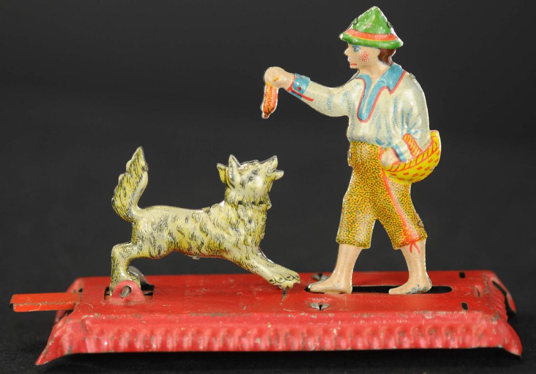 MEIER MAN FEEDING DOG PENNY TOY: 149. MEIER MAN FEEDING DOG PENNY TOY | Articulate lever causes hound to leap for meat as boy moves.