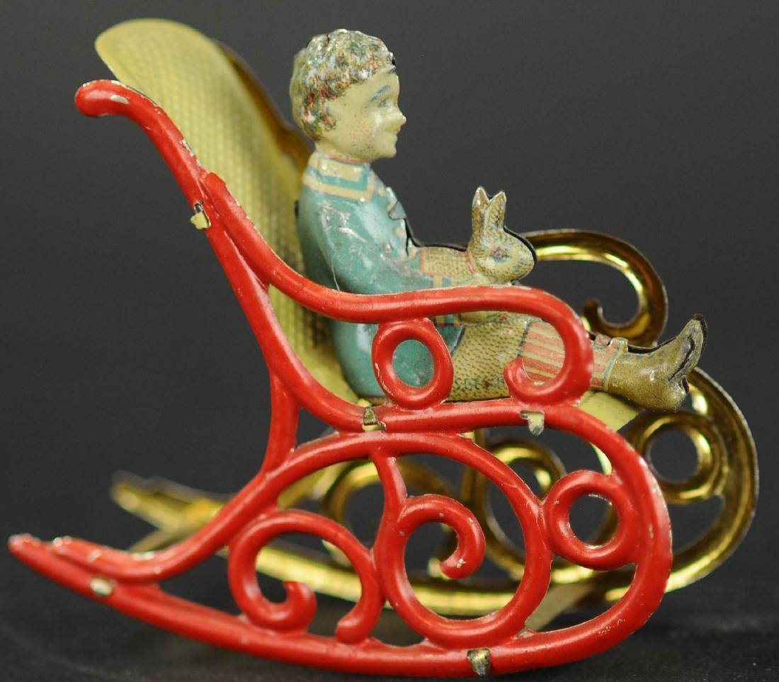 MEIER BOY W/RABBIT IN ROCKING CHAIR PENNY TOY: 164. MEIER BOY W/RABBIT IN ROCKING CHAIR PENNY TOY