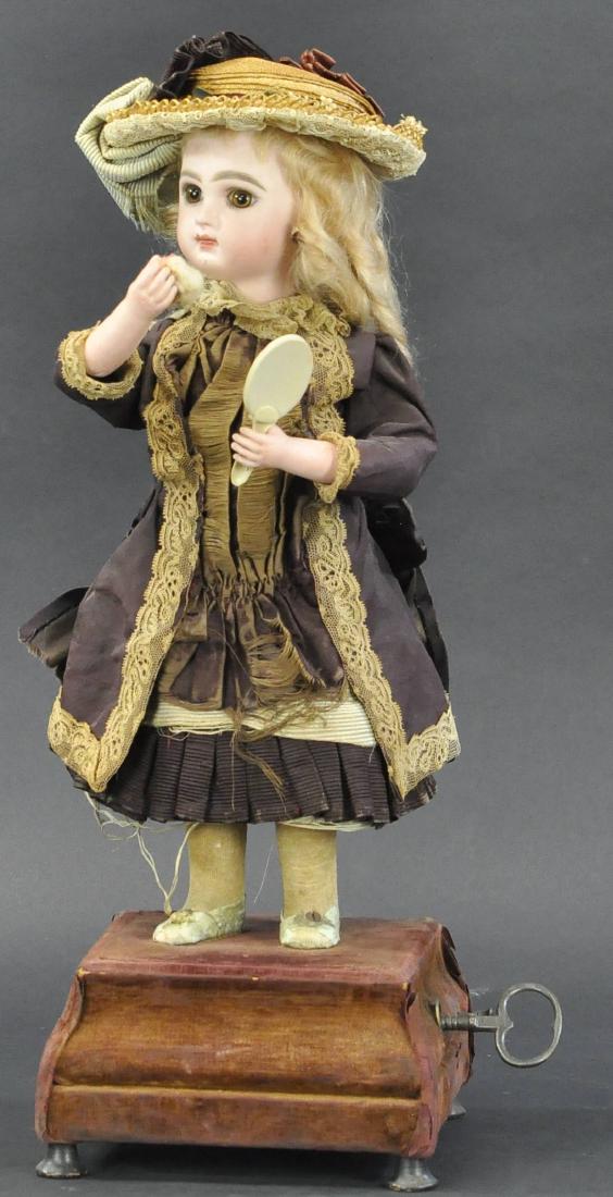 YOUNG LADY WITH MIRROR POWDERING NOSE: 208. YOUNG LADY WITH MIRROR POWDERING NOSE | French clockwork musical automaton with bisque head stamped, "Depose Tete Jumeau 4," closed neck, flat cut neck socket, wearing original mohair wig and sil