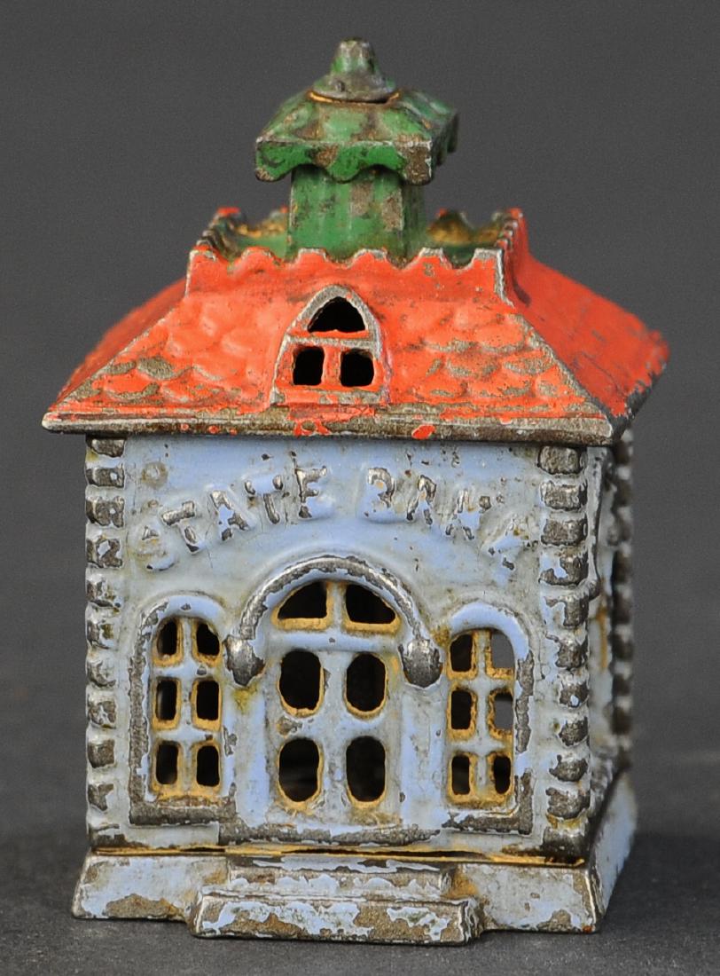 SMALL PAINTED STATE STILL BANK: 288. SMALL PAINTED STATE STILL BANK | Kyser & Rex, US | 3.5" h.