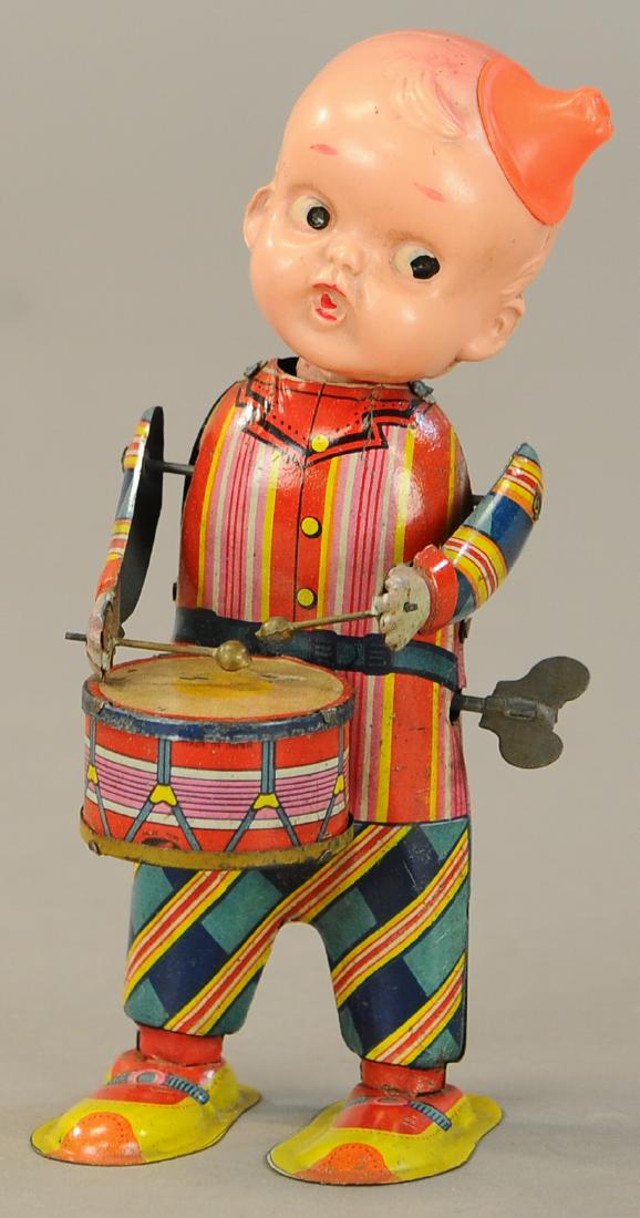 JAPANESE CELLULOID TIN DRUMMER BOY: 156. JAPANESE CELLULOID TIN DRUMMER BOY | 7" | One ankle reattached and touched up accordingly, otherwise working in All Original Condition. | $100 - $200