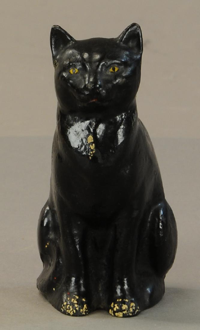 SITTING CAT DOORSTOP: 328. SITTING CAT DOORSTOP | Cast iron, interesting design of full figured black cat with flat back section to hold door. | 5.75"h. | (Near Mint Cond.) | $200 - $400