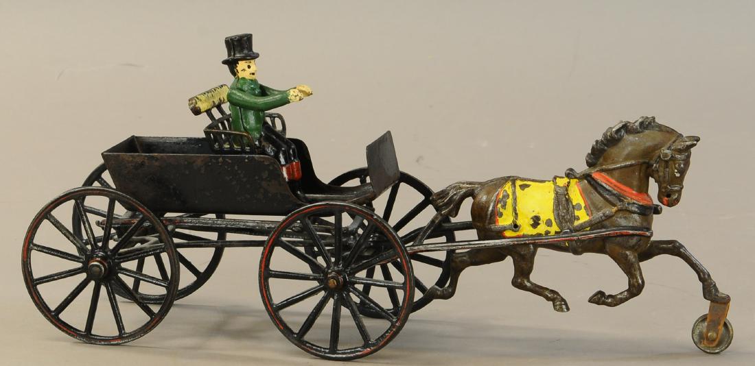 PRATT & LETCHWORTH HORSE DRAWN SURREY: 372. PRATT & LETCHWORTH HORSE DRAWN SURREY | Provenance: Max Berry Collection | 15"l. | Figure replaced, horse repainted, overall (VG Cond.) | $400 - $600