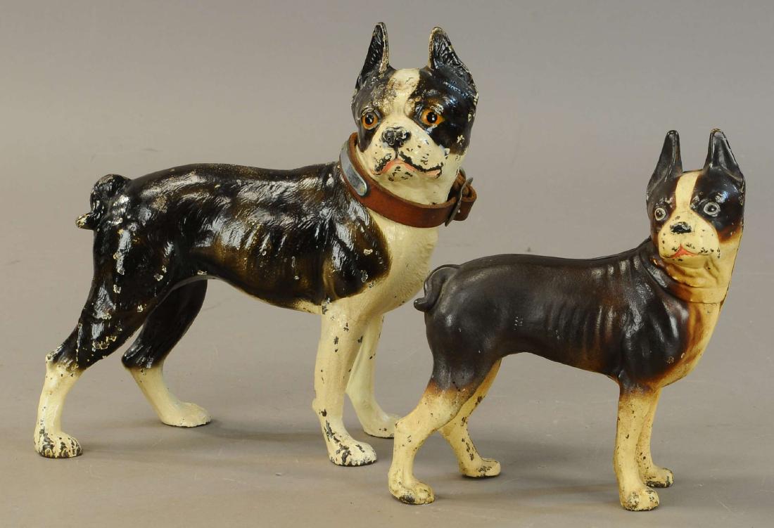 PAIR OF BOSTON TERRIER DOORSTOPS: 395. PAIR OF BOSTON TERRIER DOORSTOPS | Hubley large Boston Terrier w/ leather collar and smaller version, both full figured and facing right. | 8.75" - 10.5"h. | (Pristine Cond.) | $100 - $300