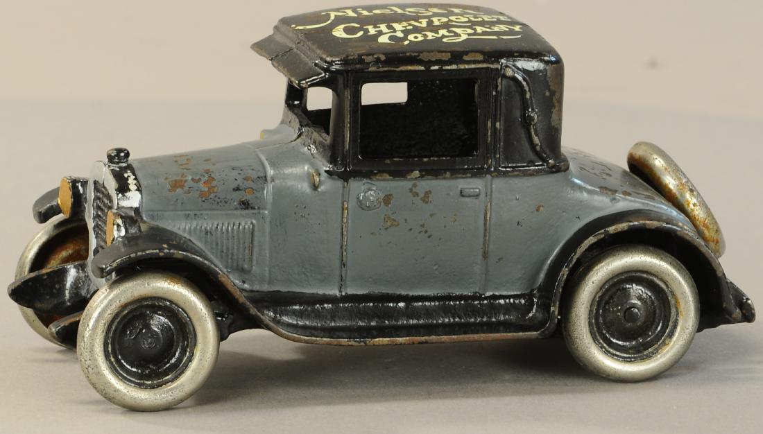 ARCADE CHEVY COUPE W/ ROOF ADVERTISEMENT: 405. ARCADE CHEVY COUPE W/ ROOF ADVERTISEMENT | 8"l. | Crack at windshield frame, otherwise (Exc. Cond.) | $800 - $1,200