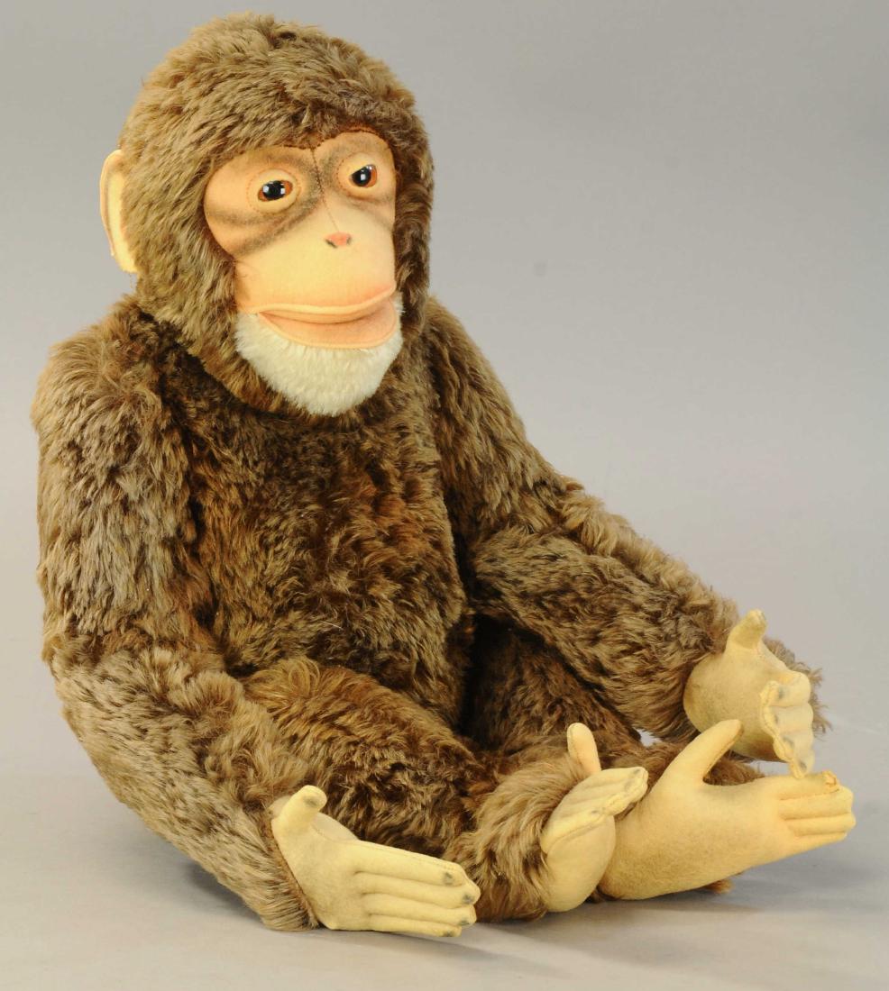 LARGE STEIFF 'JOCKO' MONKEY: 453. LARGE STEIFF 'JOCKO' MONKEY | 1950's era, jointed at neck, shoulders and hips, glass eyes, felt ears, face with white mohair chin, button in ear. | 25" (64 cm) | Tear on bottom of right ear, some