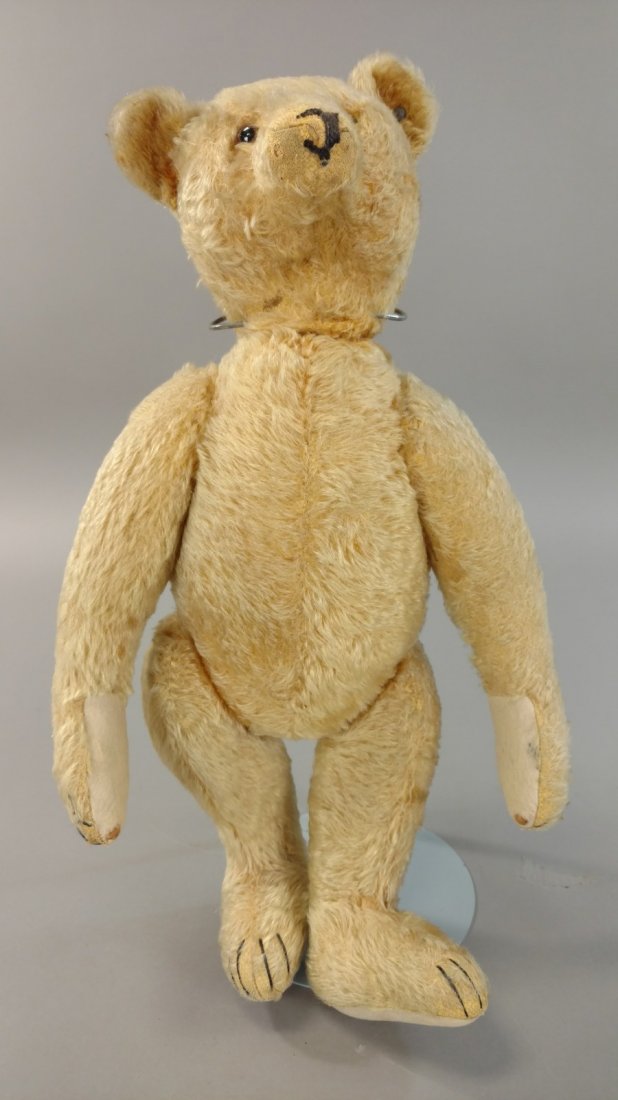 1920'S STEIFF TEDDY BEAR: 454. 1920'S ERA TEDDY BEAR | Steiff button in ear with working growler, long armed bear with slight hump on back has original paw pads with a few small moth holes, although mohair somewhat worn and fa