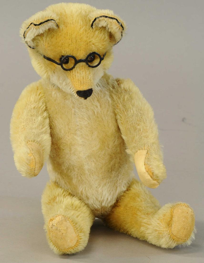SCHUCO 'YES-NO' FOX: 473. SCHUCO 'YES-NO' FOX | Seldom found and quite appealing mohair covered fox with glasses, when tail is moved, head goes from side to side and up and down. | 13". | Paw pad on left hand appears repl