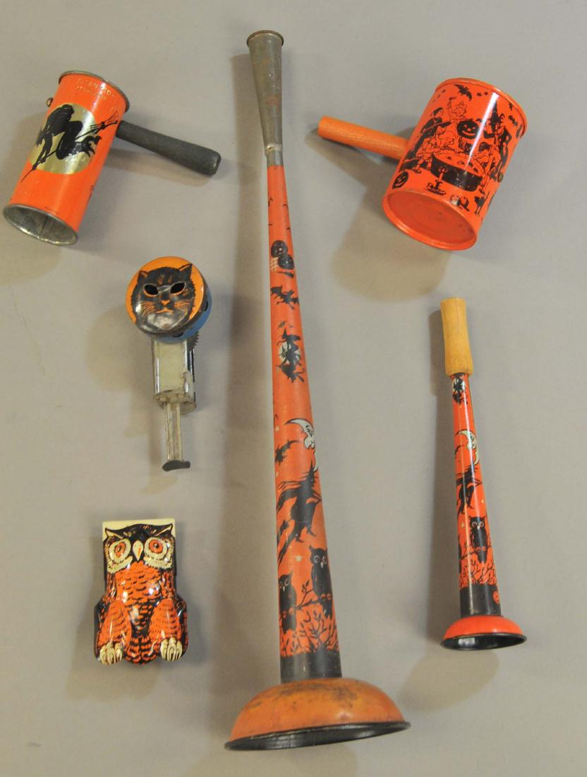 GROUPING OF SIX HALLOWEEN TIN NOISEMAKERS: 553. GROUPING OF SIX HALLOWEEN TIN NOISEMAKERS | An early black cat sparkler [needs flint], two rattles, two horns, and a clicker. | 3" - 17" l. | (VG-Exc. Cond.) | $200 - $300