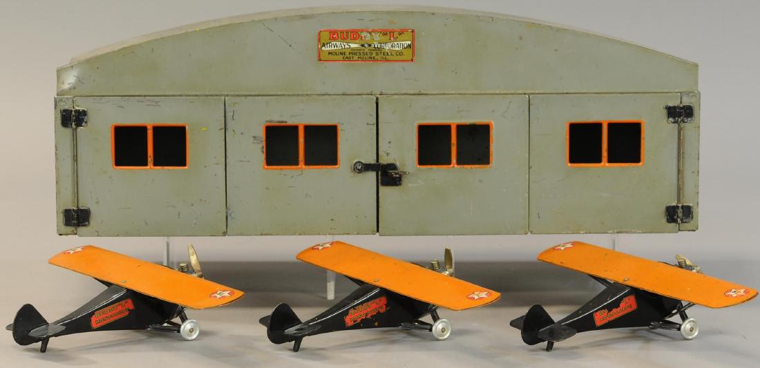 BUDDY L HANGAR W/ THREE AIRPLANES: 643. BUDDY L HANGAR W/ THREE AIRPLANES | Equal playwear to a complete set. | Hangar 20" x 8". | (VG - Exc. Cond.) | $800 - $1,200