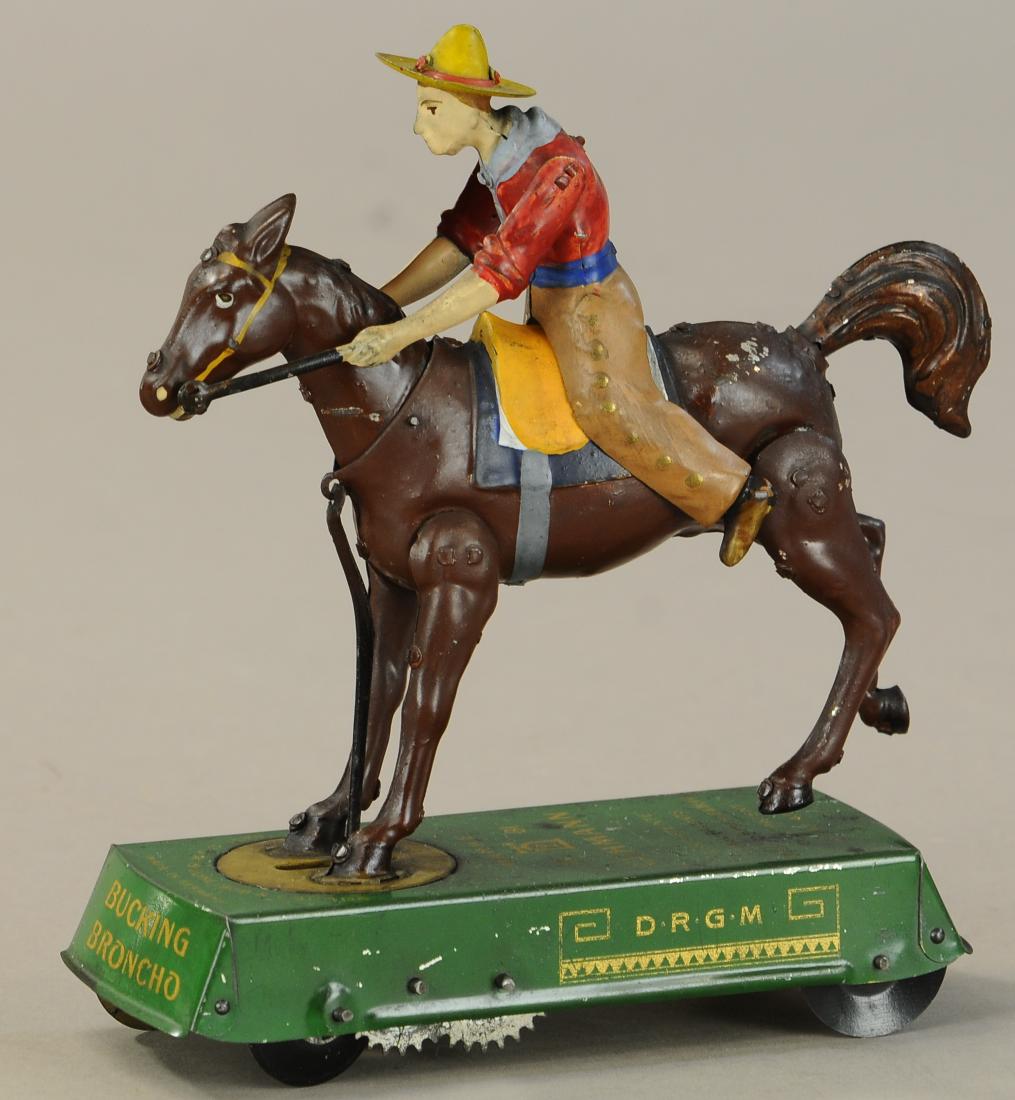 LEHMANN BUCKING BRONCO: 1085. LEHMANN BUCKING BRONCO | Brown horse version, amusing cowboy appears to flip over as horse kicks and toy rolls. | 7" l. | (Pristine Cond.) | $700 - $1,000