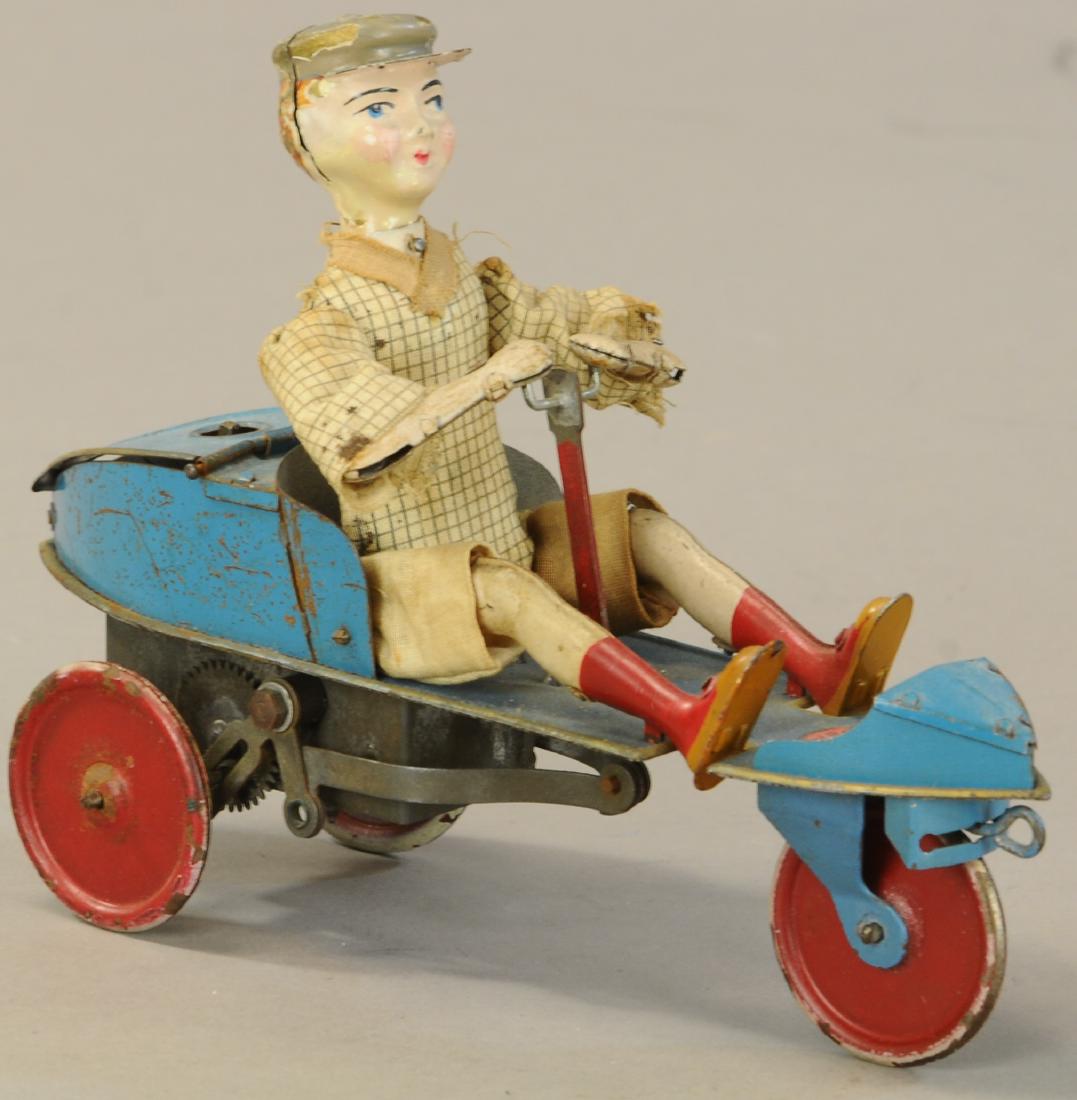 VICTOR BONNET SKIFF CART: 1106. VICTOR BONNET SKIFF CART | c. 1919-1937, "L'Entraineur Skiff," back-and-forward movement of the boy pulling the hand lever drives the skiff forward. | 7" l. | Paint enhancement to chips on face 
