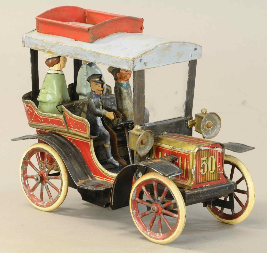 CARETTE #50 AUTO W/ FIGURES: 1129. CARETTE #50 AUTO W/ FIGURES | Popular German auto features open two row seating, the figures, roof and a portion of the fenders appear to be replacements to complete the style to an otherwise or