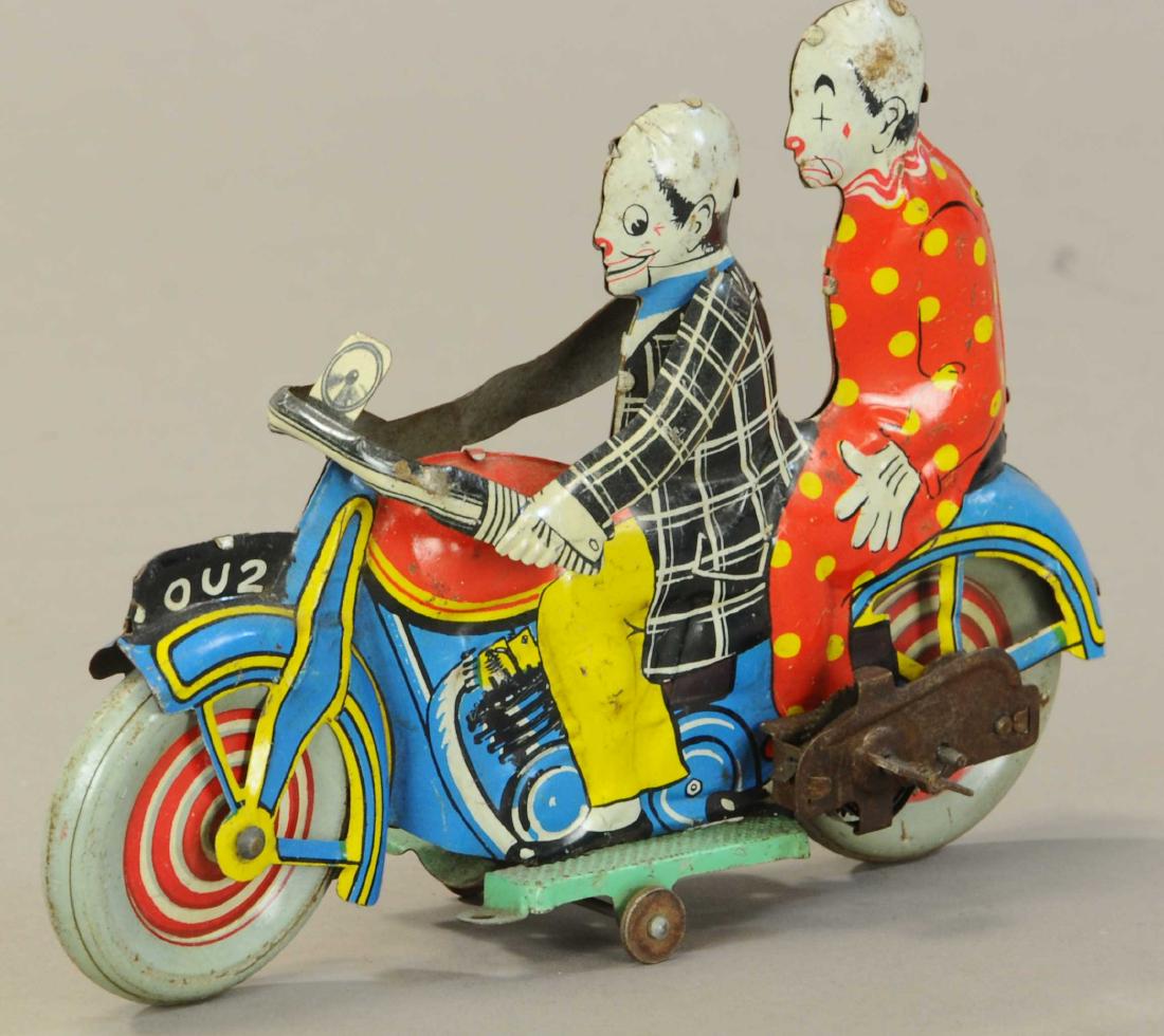 ENGLISH CLOWNS ON MOTORCYCLE: 1139. ENGLISH CLOWNS ON MOTORCYCLE | Scarce lithographed comic bike marked, "Made in Gr Britain" on side of gas tank. | 8" l. | (VG - Exc. Cond.) | $1,000 - $1,500