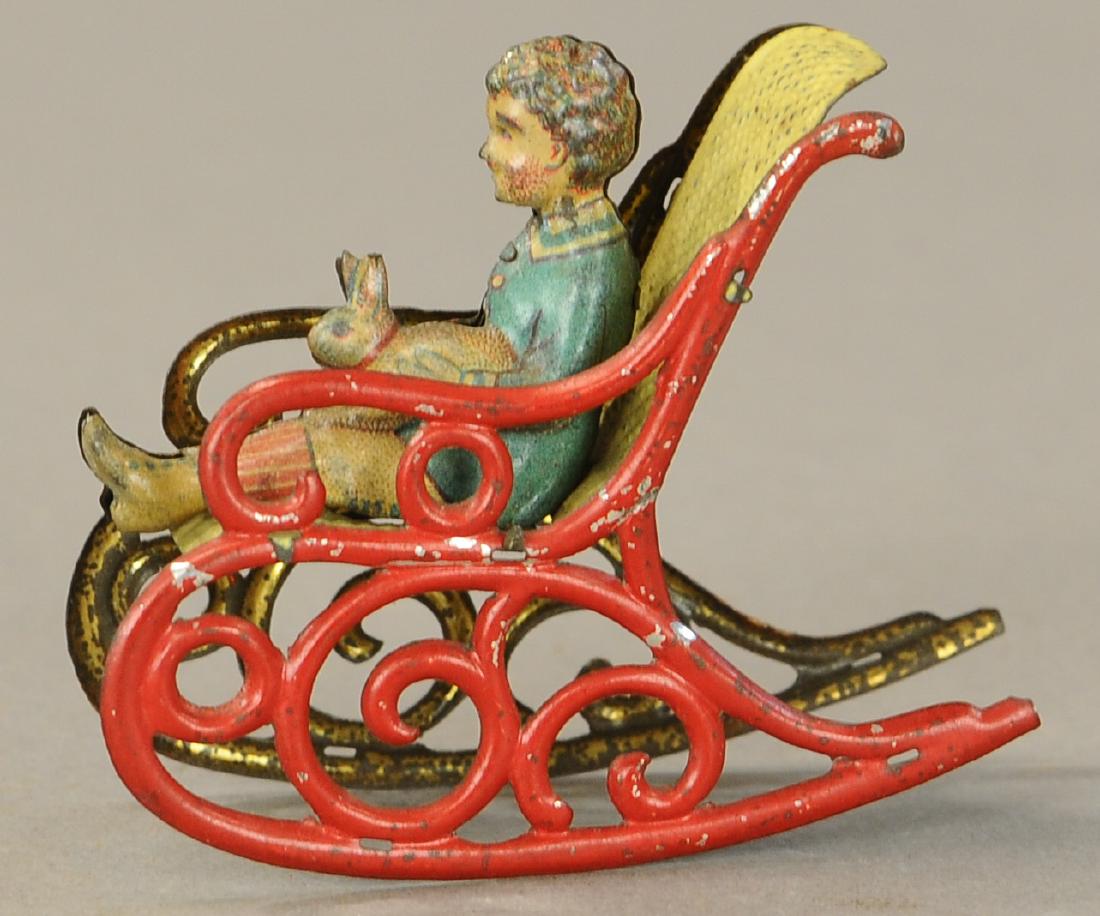 MEIER ROCKING CHAIR PENNY TOY: 1152. MEIER ROCKING CHAIR PENNY TOY | Cute theme with child holding bunny rabbit. | 3" | (VG - Exc. Cond.) | $400 - $600