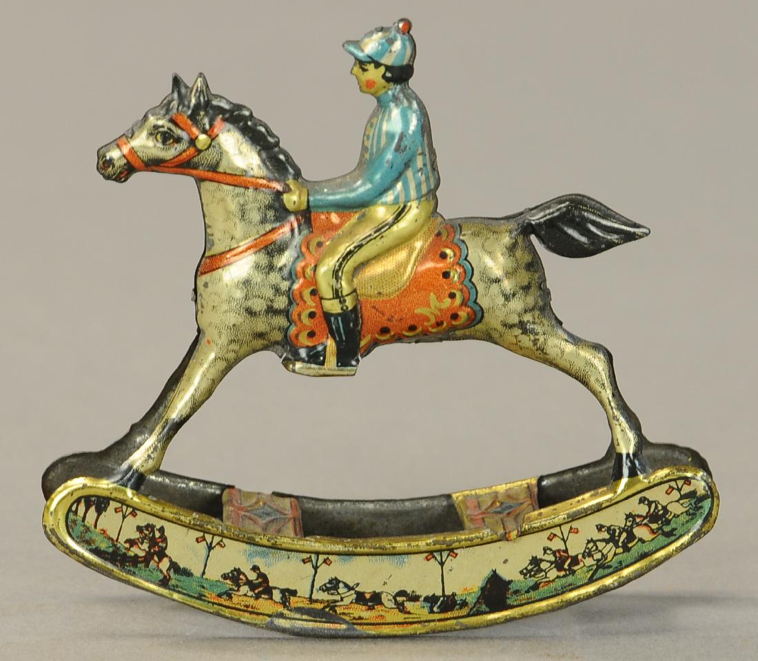 MEIER ROCKING HORSE JOCKEY PENNY TOY: 1156. MEIER ROCKING HORSE JOCKEY PENNY TOY | 4" | (Exc. Cond.) | $300 - $500