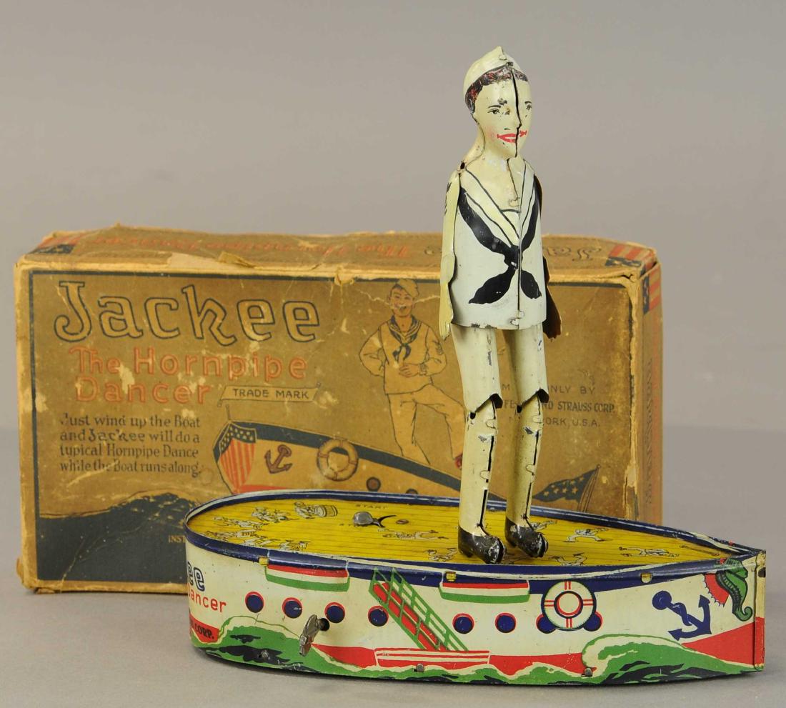 BOXED STRAUSS JACKIE THE HORN PIPE DANCER: 1230. BOXED STRAUSS JACKIE THE HORN PIPE DANCER | 9" h. | Box is complete with tears to corners, minor spot on chest, and one side of hat is touched up, both arms possibly replaced, otherwise in (Exc.
