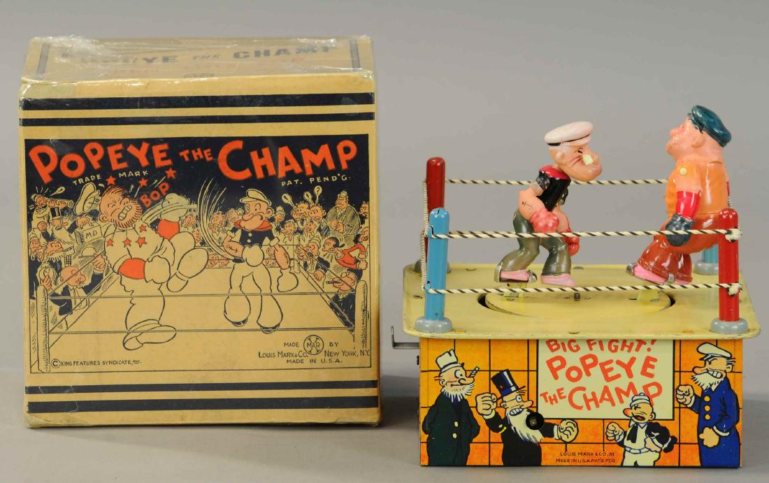 BOXED MARX POPEYE THE CHAMP: 1253. BOXED MARX POPEYE THE CHAMP | Likely old store stock example with original key still in paper wrapper. | 7.5" w. | Minor edge tears to box, toy in (Pristine - Near Mint Cond.) | $1,400 - $1,800