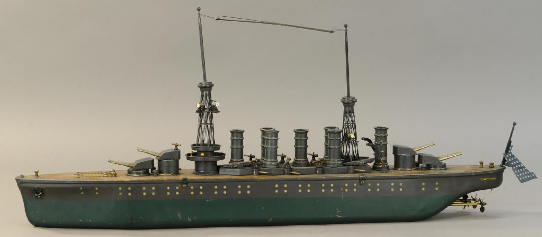 ORKIN CRAFT BATTLESHIP CONSTITUTION: 1346. ORKIN CRAFT BATTLESHIP CONSTITUTION | Wind-up motor. | 35" l. | One searchlight is replaced, otherwise appears original in (Exc. Cond.) | $1,000 - $1,500
