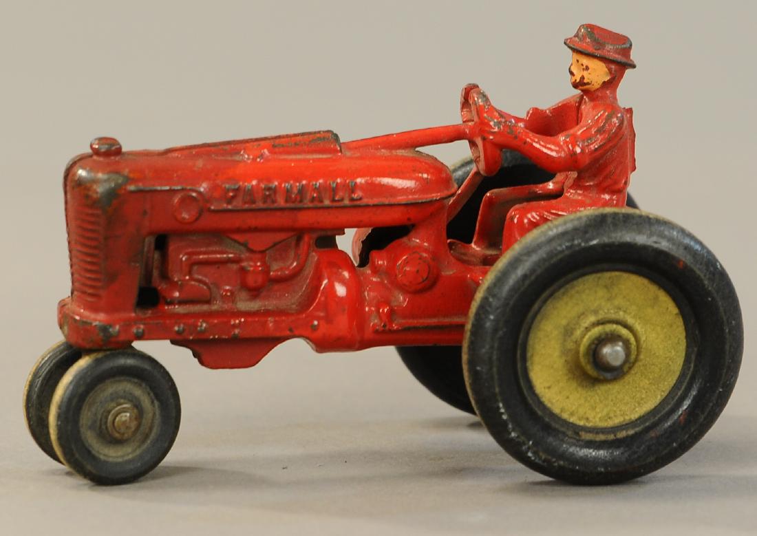 ARCADE FARMALL TRACTOR: 1016. ARCADE FARMALL TRACTOR | 5.5" l. | Front wooden wheel glued in half, paint in All Original Condition. | $100 - $200